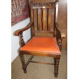 A MID 29TH CENTURY OAK CARVED BACK ARMCHAIR with drop in seat pad