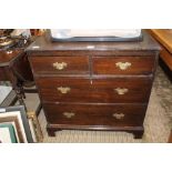 A WOODEN FOUR DRAWER CHEST on plain bracket feet