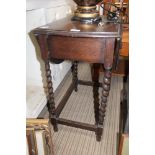 AN OAK FINISHED SMALL SIZED TWIN FLAP TABLE with barley twist legs