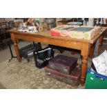A LARGE PINE RECTANGULAR TOPPED COUNTRY KITCHEN TABLE supported on four turned tapering legs