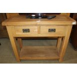 A MODERN OAK SLENDER SIDE TABLE with two inline drawers