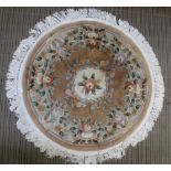 A CIRCULAR CHINESE WASHED WOOL FLOOR CARPET with floral design