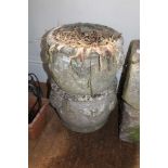 A PAIR OF WELL WEATHERED CAST CONCRETE CIRCULAR PLANTERS