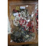 A SEALED BAG OF COSTUME JEWELLERY & associated items