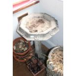 A CAST CONCRETE OCTAGONAL TOPPED BIRDBATH