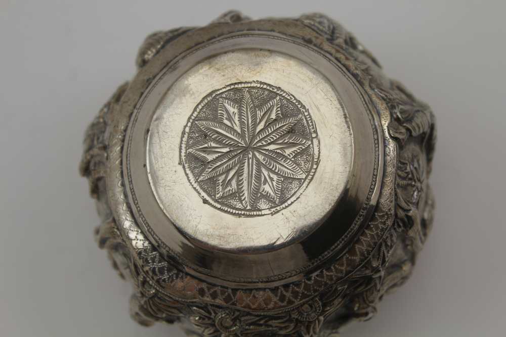 AN EASTERN WHITE METAL BOWL, repousse decoration in the round of warriors in a landscape, 6.5cm - Image 3 of 4