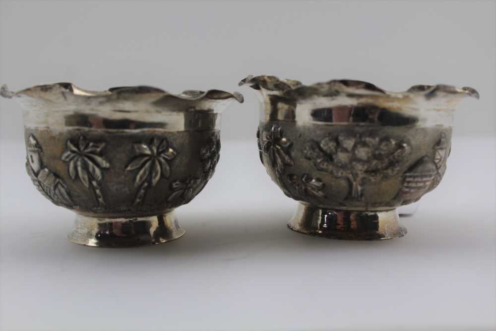 A PAIR OF EASTERN WHITE METAL SWEETMEAT BOWLS, repousse decoration in the round, landscape with palm - Image 2 of 3