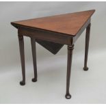 A 19TH CENTURY MAHOGANY SINGLE FLAP FOLDING TEA TABLE, triangular when shut, supported on four