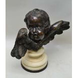 A 20TH CENTURY POSSIBLY ITALIAN CAST BRONZE CHERUB HEAD, with splayed wings, supported on a marble