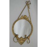A 19TH CENTURY GILT FRAMED CIRCULAR PLAIN PLATE WALL MIRROR, with decorative bow & shell top, the