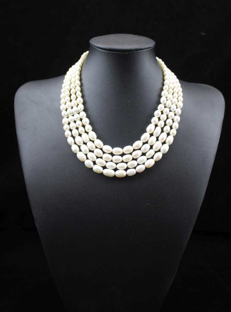 A PEARL NECKLACE, four strands of graduated cultured pearls with silver fastening,