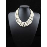 A PEARL NECKLACE, four strands of graduated cultured pearls with silver fastening,