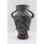 A THRACIAN WARRIOR DESIGN POTTERY VASE, of baluster form, with mask decoration, fitted two