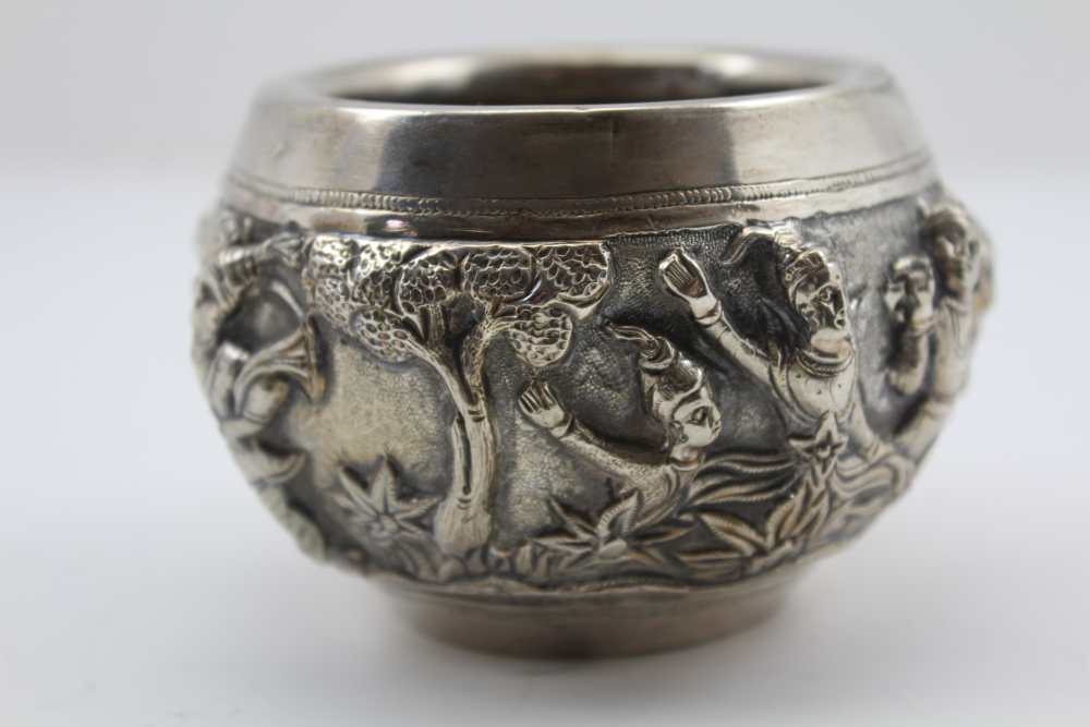 AN EASTERN WHITE METAL BOWL, repousse decoration in the round of warriors in a landscape, 6.5cm