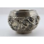 AN EASTERN WHITE METAL BOWL, repousse decoration in the round of warriors in a landscape, 6.5cm