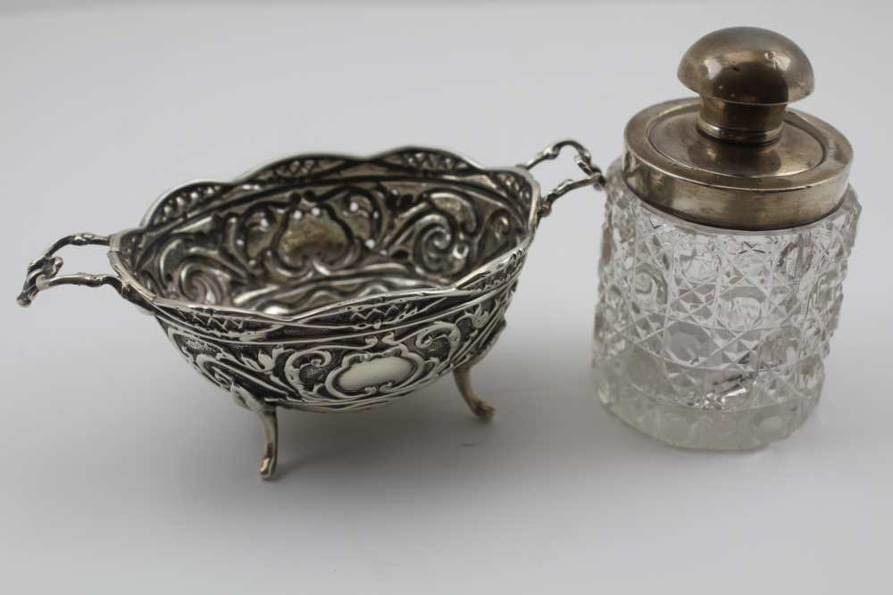 HENRY MATTHEWS A VICTORIAN SILVER SWEETMEAT DISH, of twin handle design, repousse decoration,