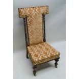 A 19TH CENTURY HIGH BACKED NURSING CHAIR / PRIE-DIEU, having turned and reeded pilaster supports,