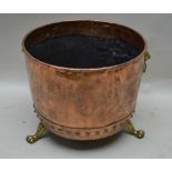 A LATE 19TH / EARLY 20TH CENTURY RIVETED COPPER LOG BIN, with lion ring mask handles, supported on