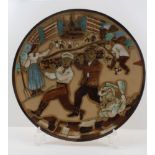 A MID 20TH CENTURY RUSSIAN POTTERY WALL CHARGER, sgraffito and glazed with a scene of figures at