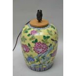 AN ORIENTAL DESIGN POTTERY VASE decorated with birds and peony, on a yellow ground, converted to a