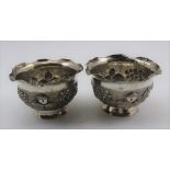 A PAIR OF EASTERN WHITE METAL SWEETMEAT BOWLS, repousse decoration in the round, landscape with palm