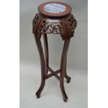 A CHINESE DESIGN INSERT MARBLE CIRCULAR TOP JARDINIERE STAND, with pierced apron, supported on