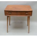 AN ERCOL SIDE TABLE, fitted single full-width drawer, supported on four plain splayed beech legs,