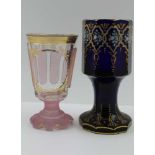 TWO 19TH CENTURY BOHEMIAN SPA GLASSES, one cobalt blue of faceted form on tapering stem, gilded