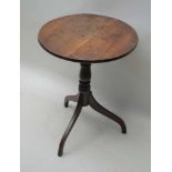 A 19TH CENTURY OAK CIRCULAR TOPPED TABLE on turned column and three downswept legs, 68cm high,