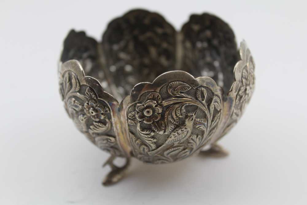 AN EASTERN WHITE METAL BOWL, of lobed form, decorated with birds amidst flowers, raised on three - Image 2 of 4