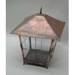 A FIRST QUARTER 20TH CENTURY COPPER FRAMED HANGING LANTERN, with plain glazed panel sides, 42cm high