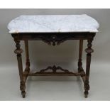 A 19TH CENTURY FRENCH MARBLE TOPPED CENTRE TABLE, with fancy carved base, supported on four reeded