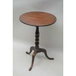 A 19TH CENTURY MAHOGANY TILT TOP TABLE on fancy turned column and three downswept legs, with pad