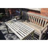 THREE PIECES OF WELL-WEATHERED TEAK SLAT BUILT GARDEN FURNITURE comprising; one three-person