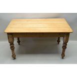 A 19TH CENTURY PINE PLANK TOPPED TABLE on four turned legs, with castors below, 76cm x 137cm