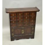 A 20TH CENTURY SOFTWOOD CHINESE DESIGN MEDICINE STYLE CABINET, having 16 slender drawers, over plain