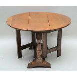 A 20TH CENTURY OAK TWIN FLAP COFFEE TABLE, with single gateleg action, supported on turned