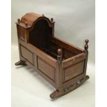 A PART 19TH CENTURY ADAPTED OAK CHILD'S ROCKING CRIB, with panelled sides and applied turned