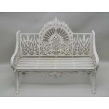 A 20TH CENTURY CAST IRON GARDEN BENCH fashioned in the Coalbrookdale style, finished in white,