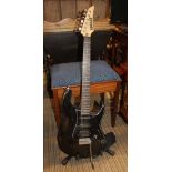 A BLACK FINISHED YAMAHA STRATOCASTER DESIGN ELECTRIC GUITAR on stand