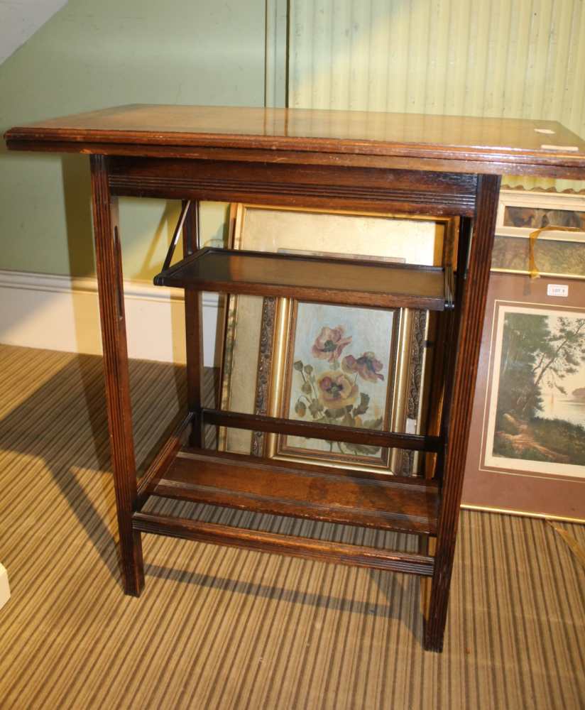 AN OAK FINISHED SWIVEL TOPPED FOLDING CARD TABLE, having folding undertier - Image 2 of 2