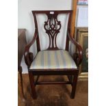 A 19TH CENTURY MAHOGANY FINISHED ARMCHAIR with pierced slat back
