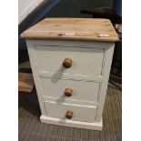 A PART PAINTED PINE THREE DRAWER BEDSIDE UNIT