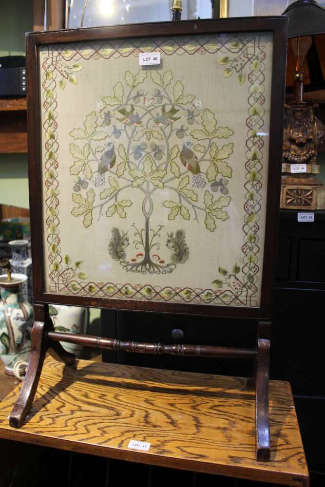 A GLAZED ARTS & CRAFTS STYLE TAPESTRY depicting flora & fauna, currently mounted as a firescreen