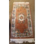 A THIN CHINESE WASH WOOL FLOOR RUG with double tasselled fringe