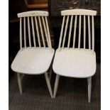 A PAIR OF WHITE PAINTED SPINDLE BACKED SOLID SEATED KITCHEN CHAIRS