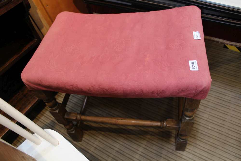 A RECTANGULAR PAD TOPPED STOOL on turned and block legs