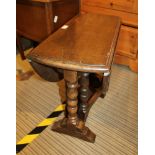 A WELL MADE REPRODUCTION OAK FINISHED TWIN FLAP GATELEG COFFEE TABLE