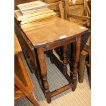 A REPRODUCTION OAK FINISHED TWIN FLAP GATELEG TABLE on lightly turned and block legs