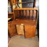 A MID-CENTURY WRITING CUPBOARD with fall-down flap over twin plain doors